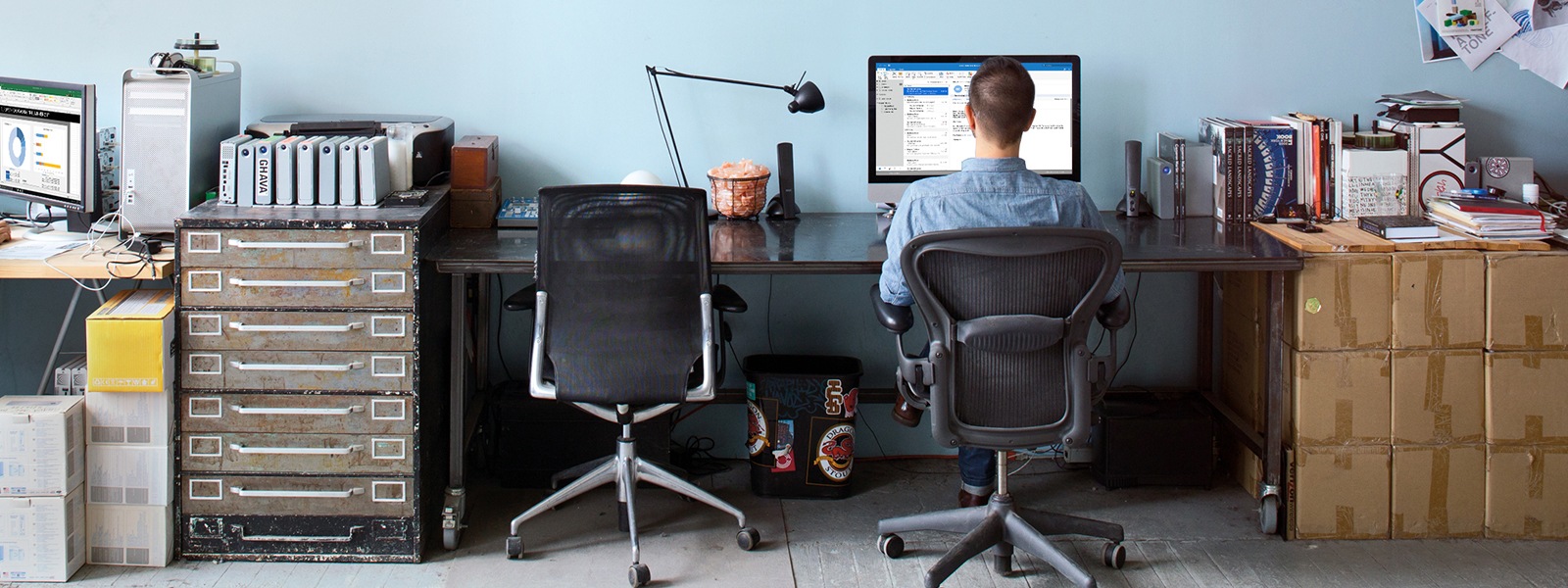 Man sitting at office desk on computer