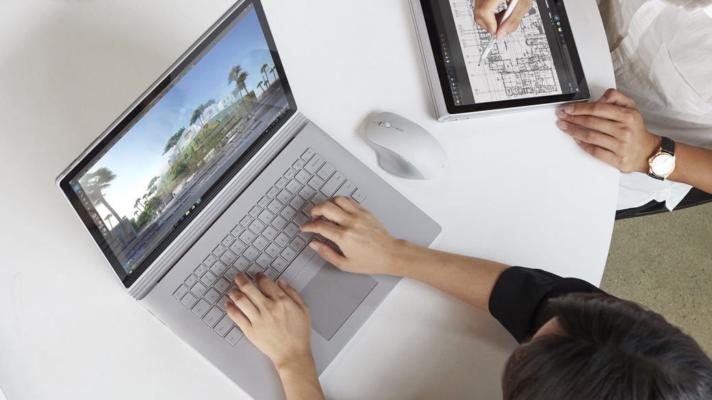 Photograph of Surface Book with Surface Precision Mouse sitting next to it.