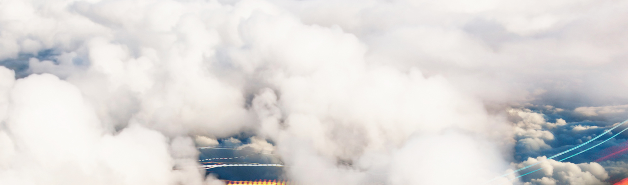 View through clouds at blurred highway below