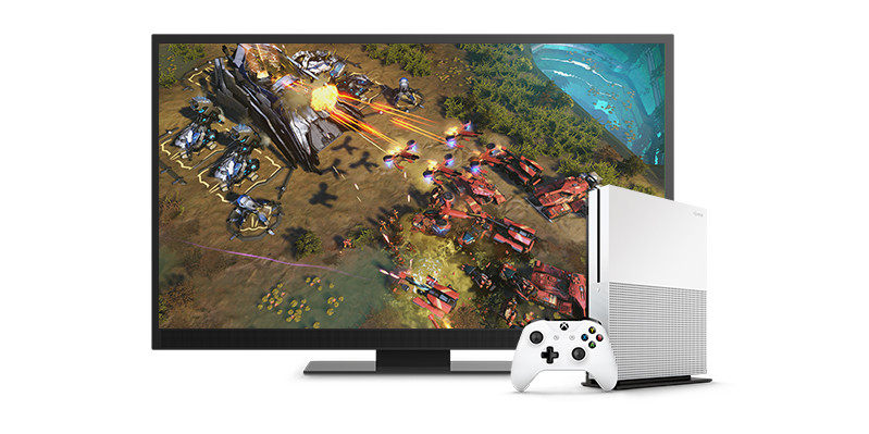 Monitor with game screenshot and Xbox with controller.