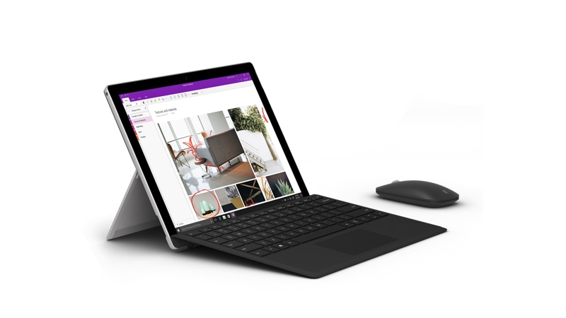 Left view of the Surface Mobile Mouse next to a Surface Pro