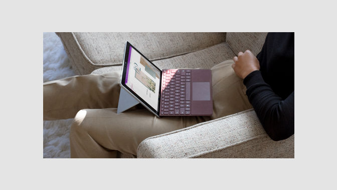 Surface Lingo with a Burgundy Surface Go Signature Type Cover on a person's lap