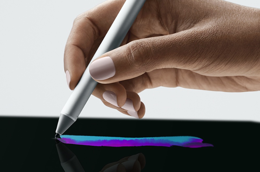 A person holds Surface Go in their hands