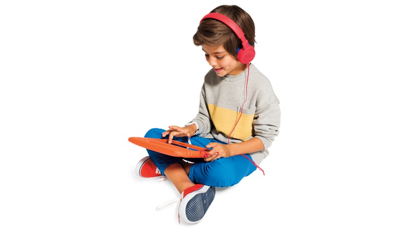 boy using a tablet and wearing red JBL JR300 headphones