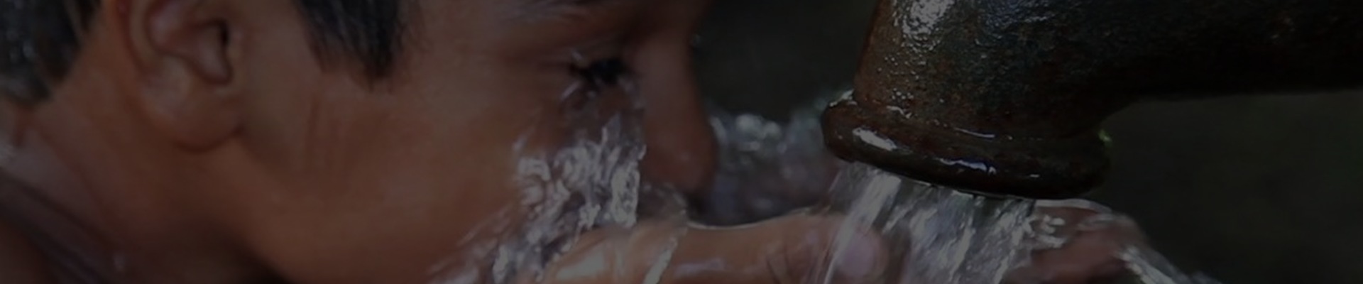 A child drinking clean water from a well