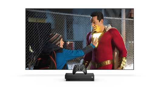 TV screen showing a boy touching a man chest that is lit up in a superhero costume.