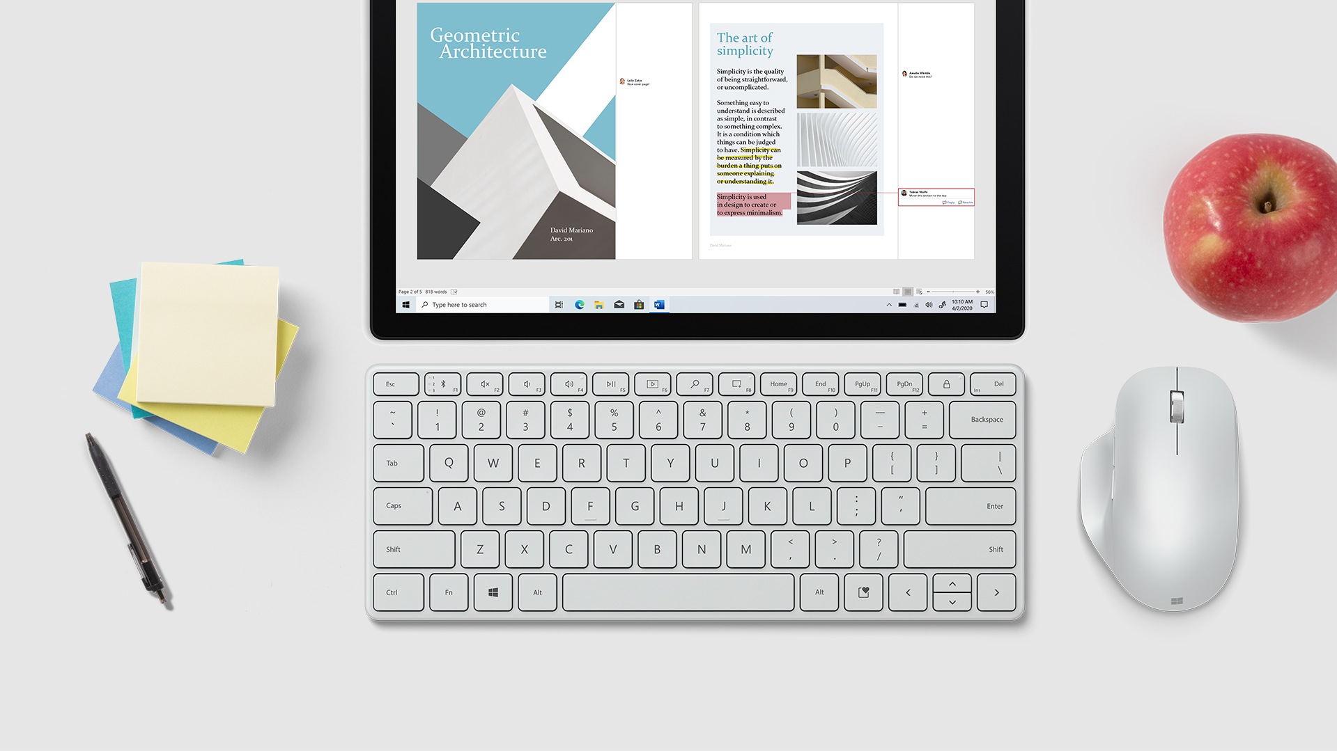 Microsoft Designer Compact Keyboard sits in front on a tablet screen next to a Microsoft mouse, pieces of paper and a pen.