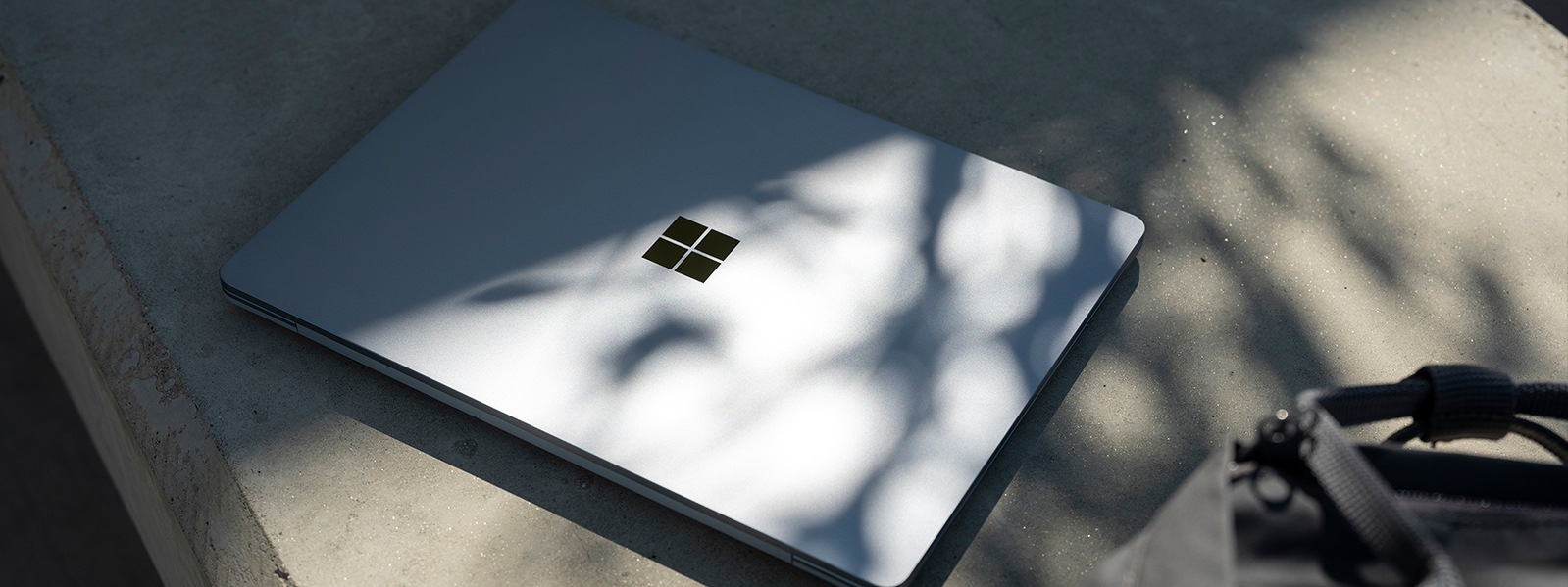 Surface Laptop Go closed, on a bench