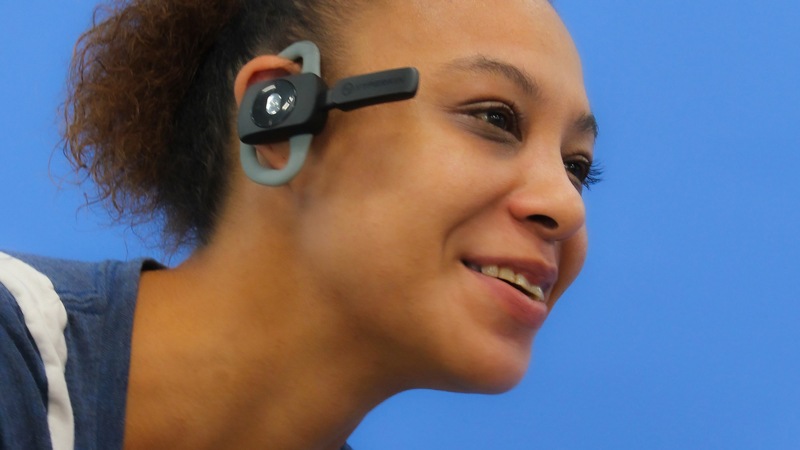 A woman wearing the Hyperkin X88 Wireless Legacy Headset for Xbox One/Xbox Series X/Windows 10
