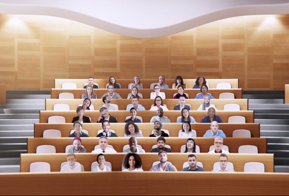 View of a group video call in Together mode with all participants appearing in seats in a virtual auditorium.