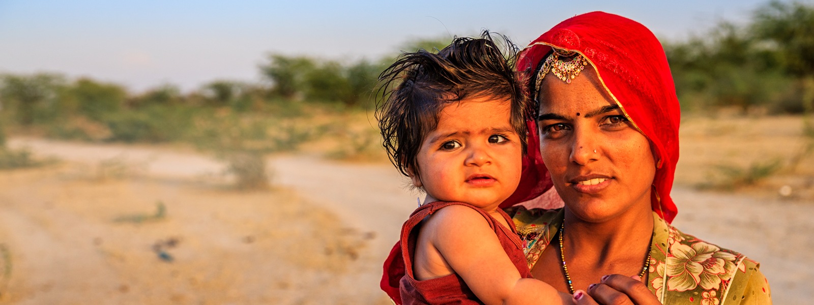 Young Indian woman holding her little baby, India
