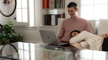 Couple enjoys browsing and streaming videos with the high-resolution PixelSense™ Display on Surface Laptop 3
