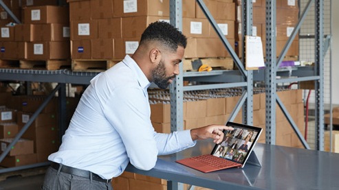 A person interacts with their Surface Pro 7+‎ while in a virtual meeting