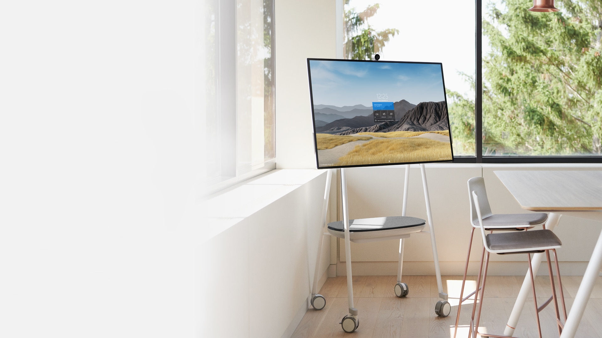 A Surface Hub 2S in the 50-inch size is shown in an office setting