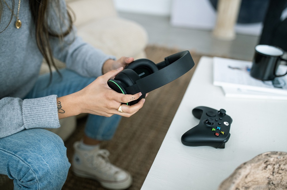 Pick up the Xbox Wireless Headset from a coffee table and prepare to play a game
