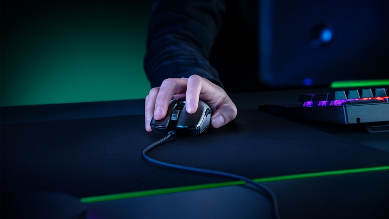 A gamer using the Razer Viper 8KHz Ambidextrous Wired Gaming Mouse at their desk