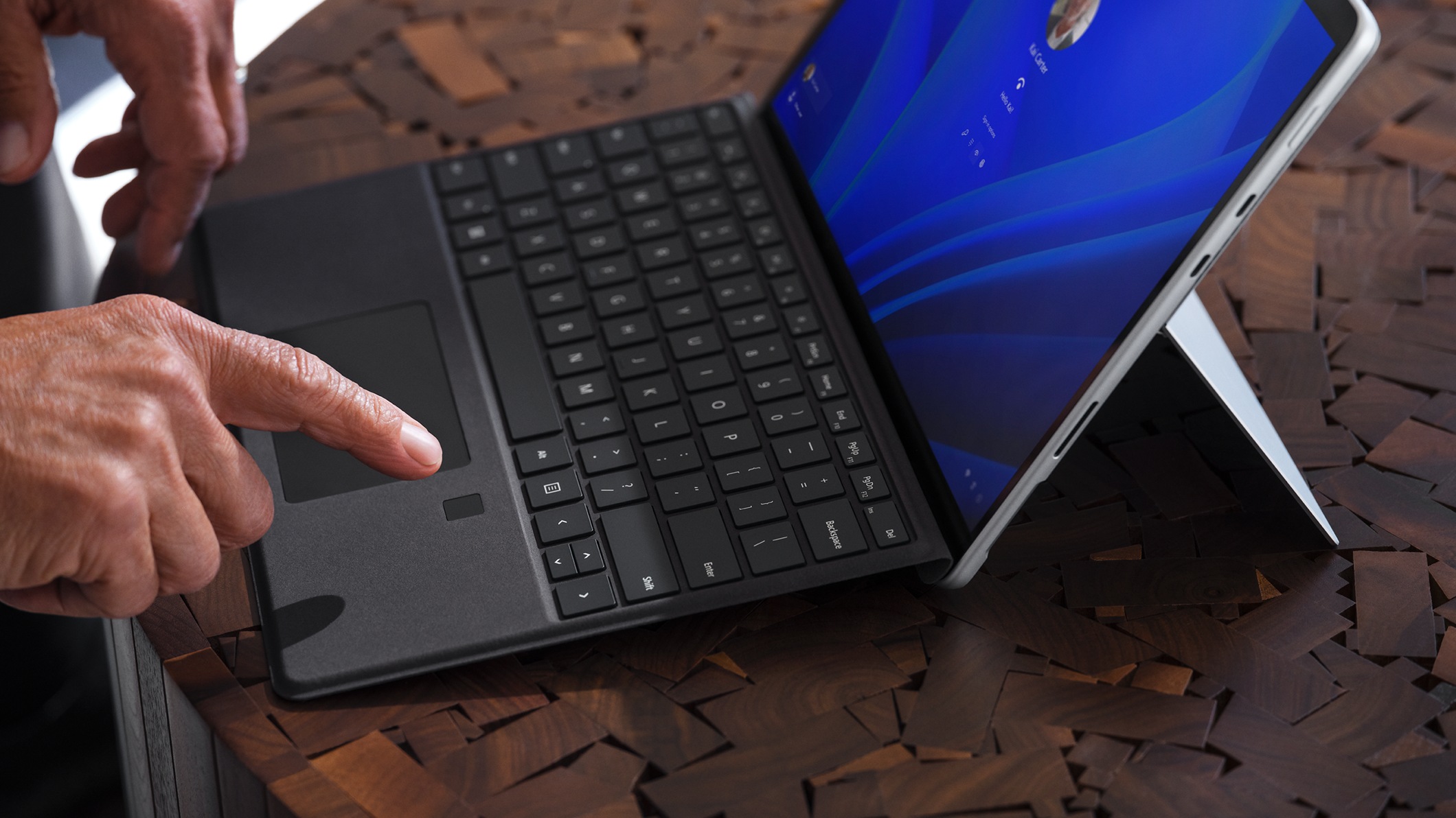 A person’s finger interacting with Surface Pro Signature Keyboard with Fingerprint Reader for Business.