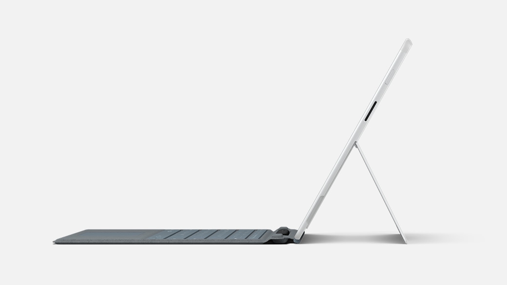Side view of Surface Pro X for Business propped up on its Kickstand with a Type Cover attached.