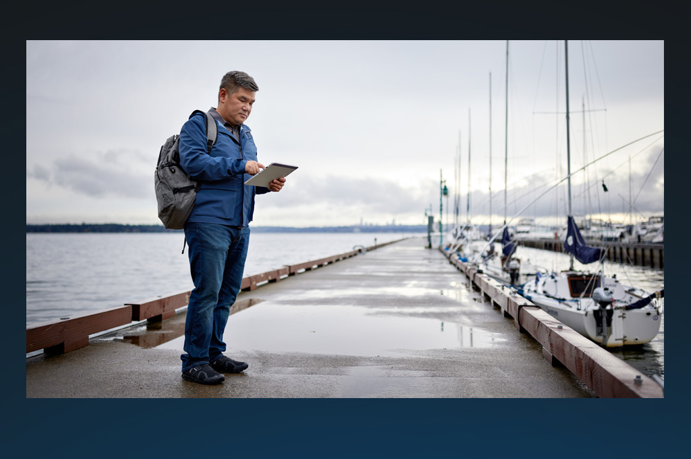 A man standing outside with a mobile device