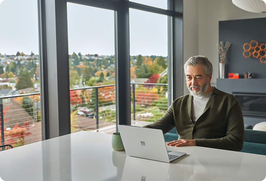 A person interacts with their Surface Laptop Go 2 in a remote work scenario