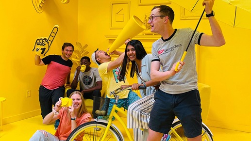 The Mentra team having fun in a yellow-colored room
