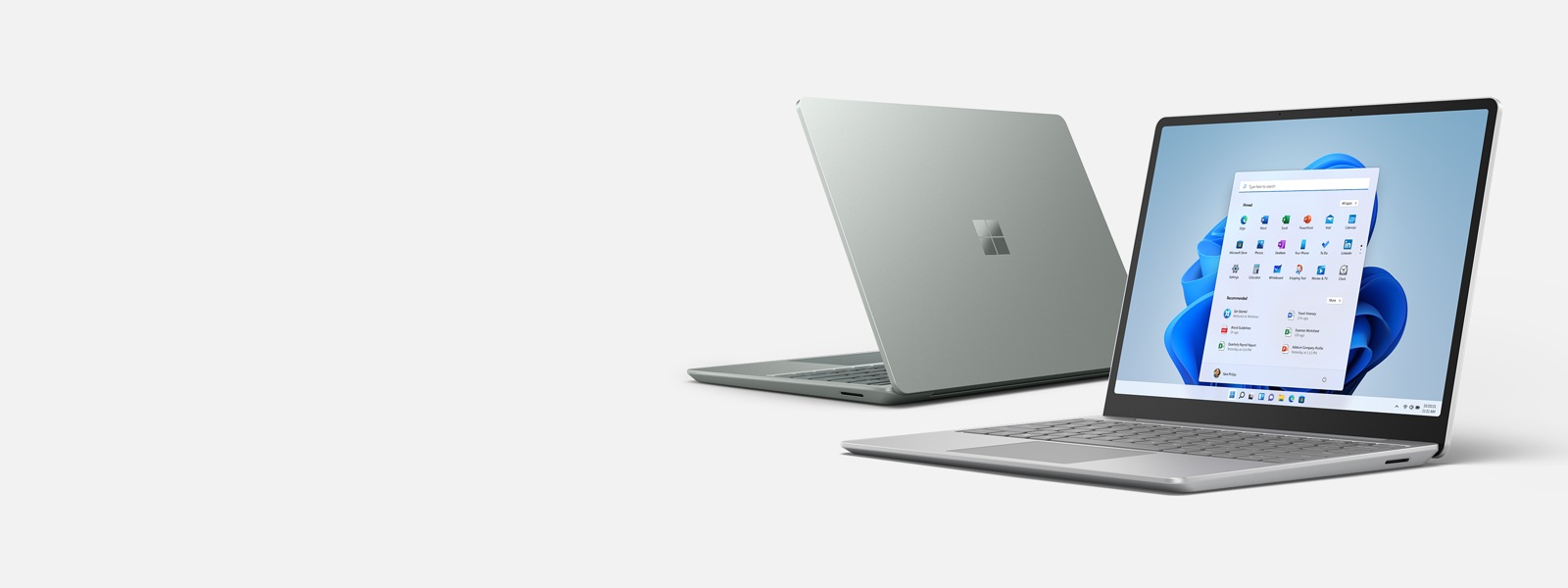 Two Surface Laptop Go 2 devices in the colours Platinum and Sage.