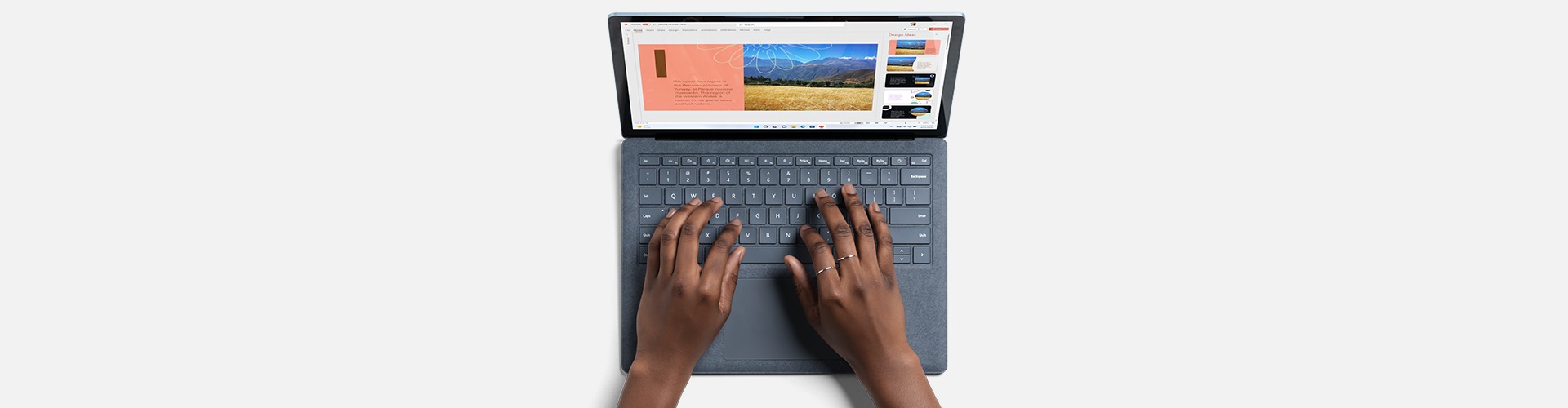 A person’s hands typing on a Surface Type Cover.