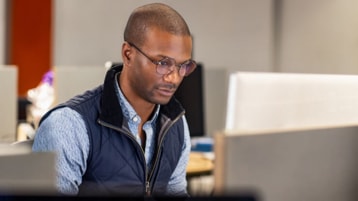 Black male developer at work in an Enterprise office workspace.