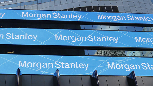 Morgan Stanley written in white across three pieces of blue horizontal signage outside of a building.
