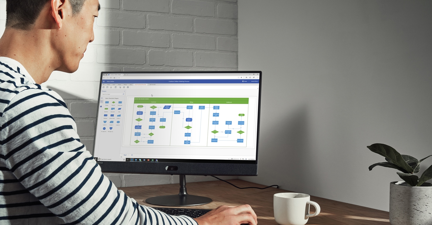 Photograph of a person looking at Visio templates on a desktop monitor
