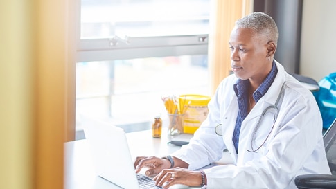 Doctor working in-front of a laptop