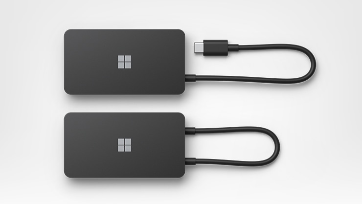 Top view of two Surface Microsoft Surface 127W Power Supply for Business showing connecting cables