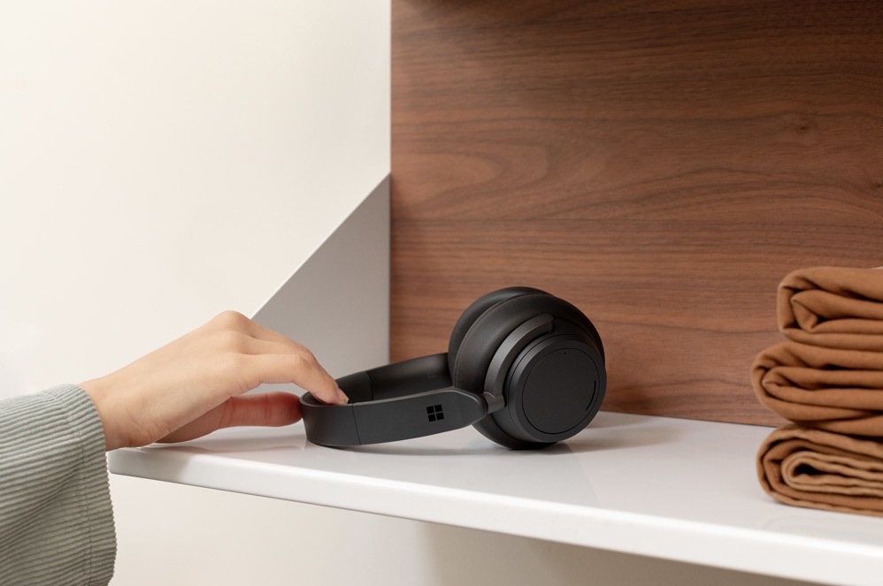 A person picks up Headphones 2 off of a shelf