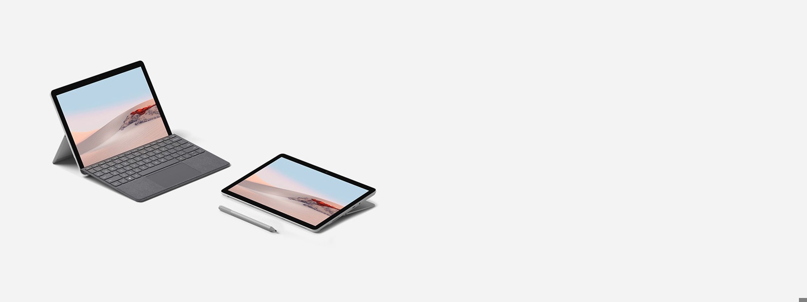 プラチナの Surface Go Signature タイプ カバーをつけたラップトップモードの Surface Go 2 および スタジオモードと Surface ペン