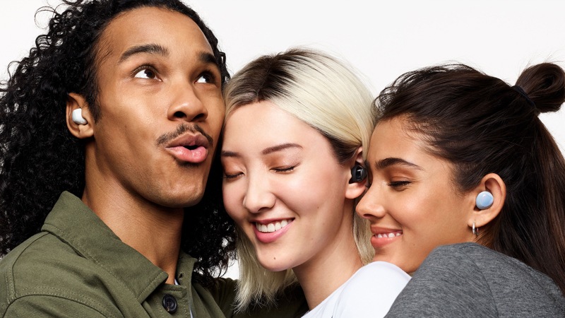 Front view of a man and 2 women close together wearing Samsung Galaxy Buds+