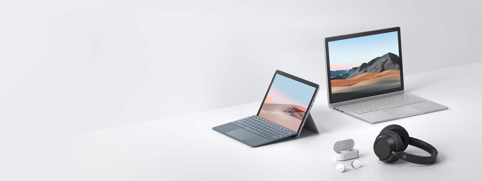 Surface Go 2, Surface Book 3, Surface Earbuds, and Surface Headphones 2 on tabletop