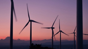 Wind turbines and a purple sunset