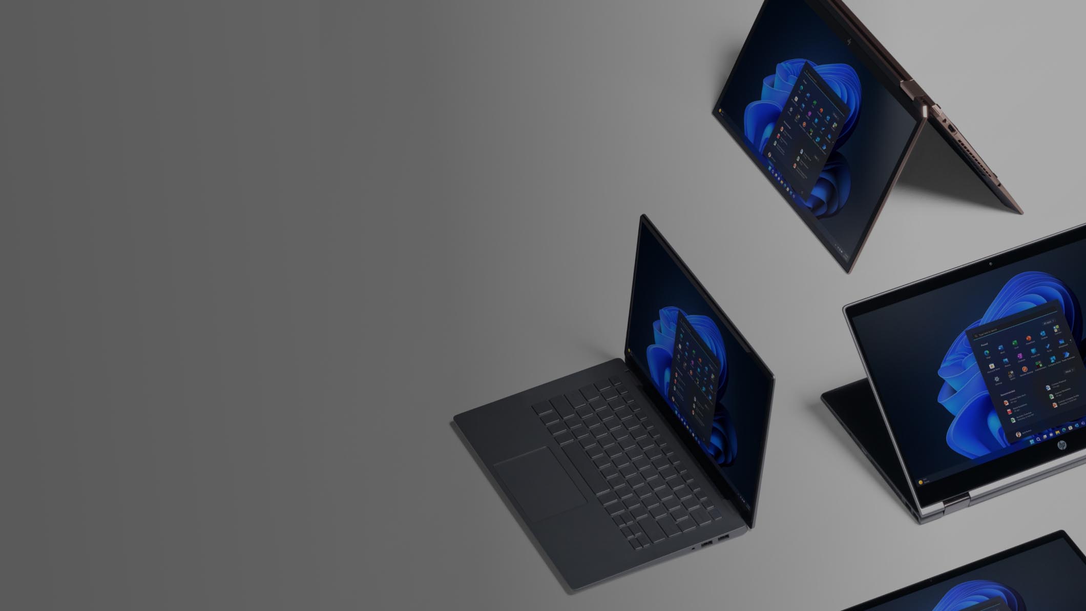 Four devices displaying the Windows 11 start screen