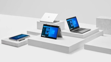 Several Windows laptops are displayed on a set of display boxes.