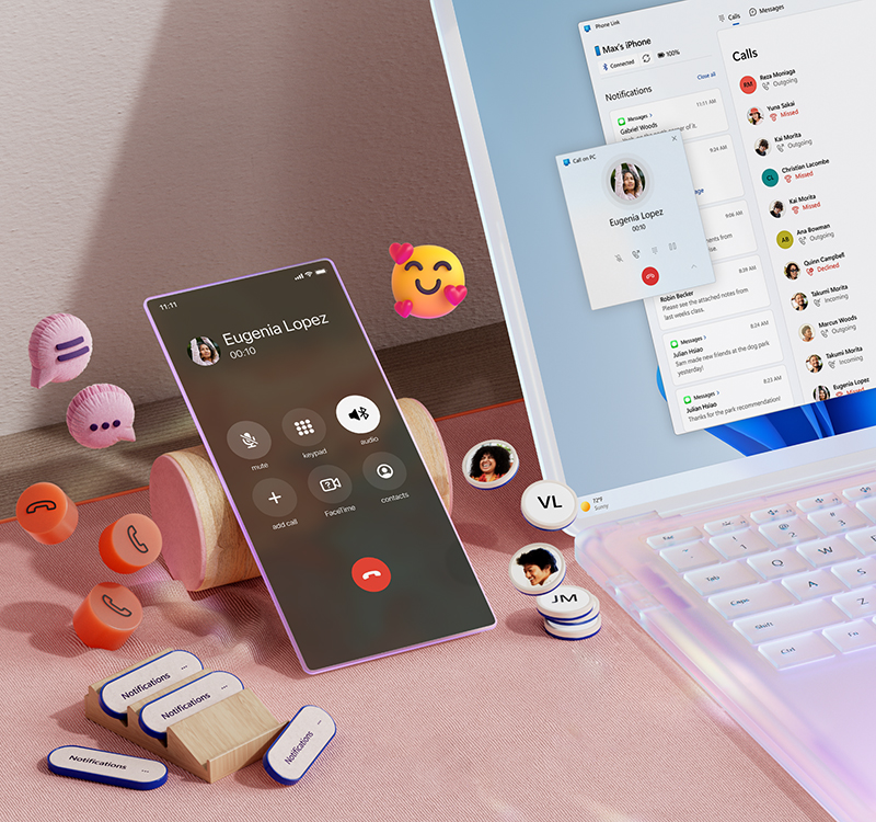 Una portátil abierta junto a un celular e iconos de emoji flotantes