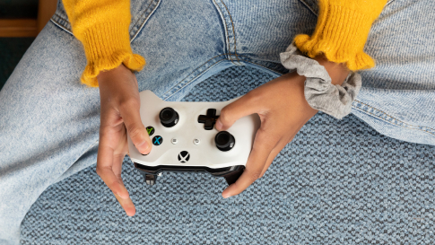 Person holding gaming controller