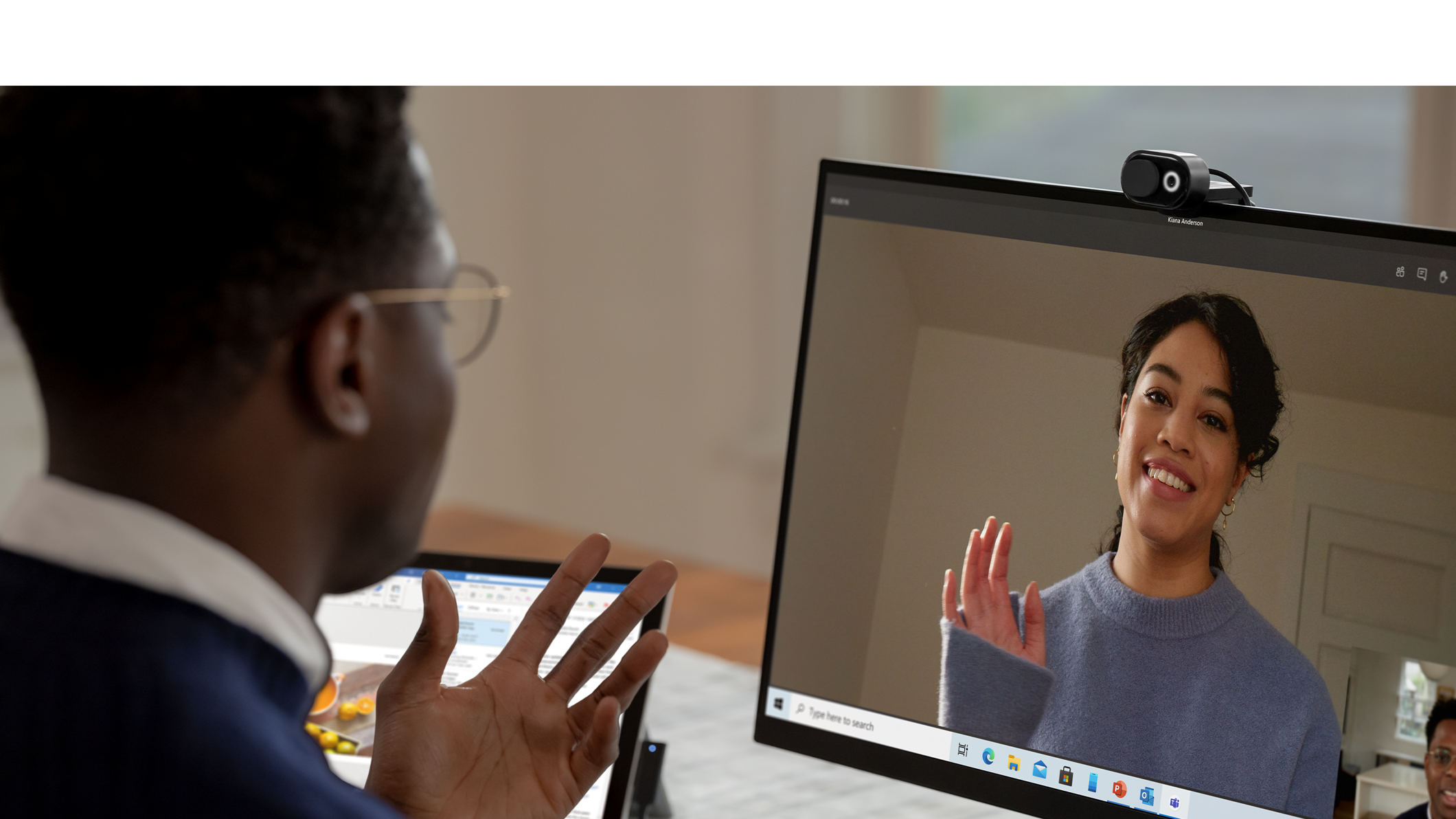 A person with their Microsoft Modern Webcam set up on a Surface device while engaging in a video call.