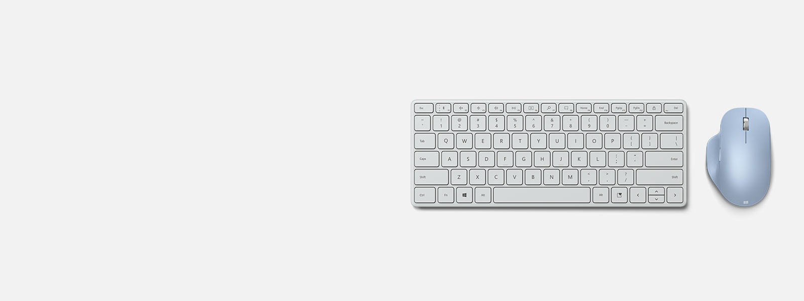 Компактна клавіатура Microsoft Designer Compact Keyboard поруч із ергономічною мишею Microsoft Bluetooth Ergonomic Mouse
