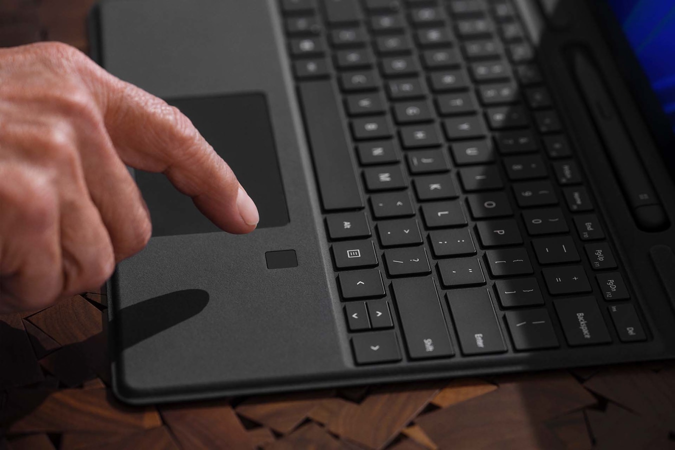 El dedo de una persona sobre la característica de inicio de sesión mediante datos biométricos de Teclado Signature para Surface Pro