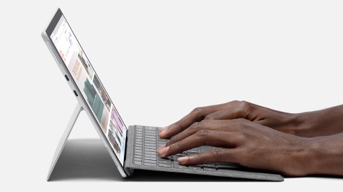 A person using Surface Pro Signature Keyboard.