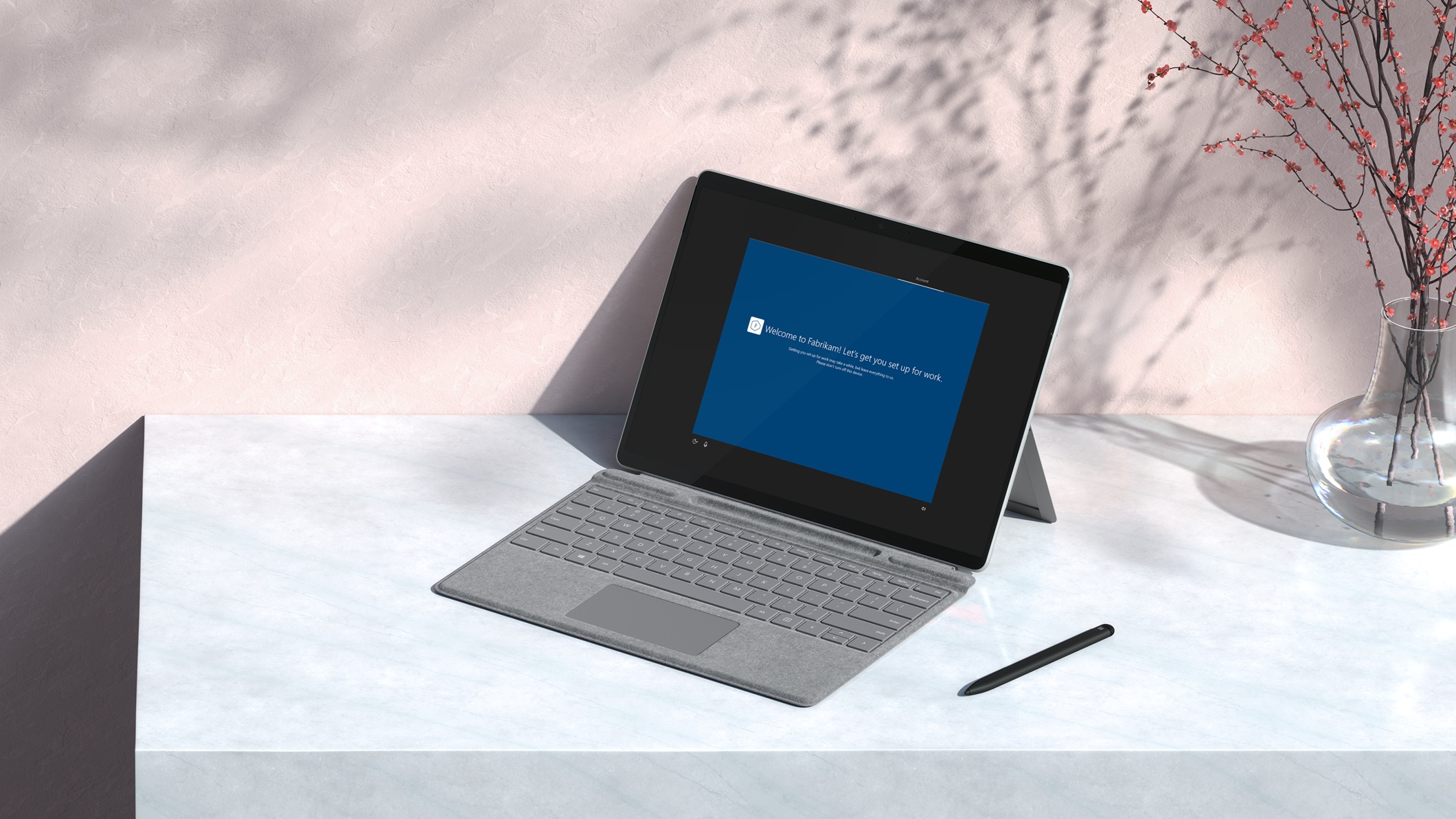A Surface Pro X with Windows Autopilot on its screen.