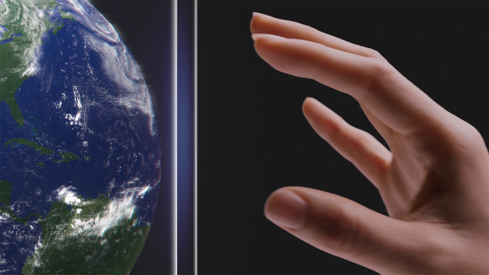 A hand reaching out to touch a 3D AR rendering of a globe.
