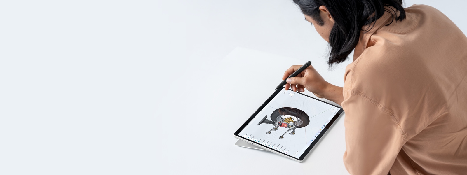 A person holding a Surface Pen working with Surface Pro 8.