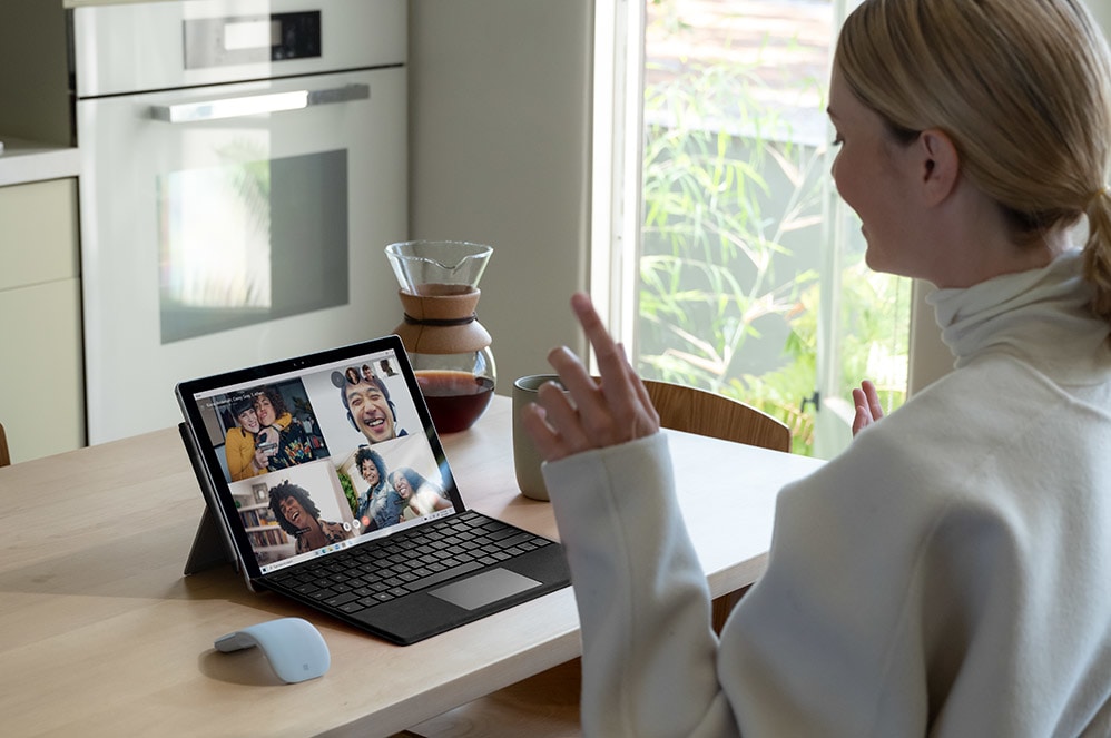 A person using Surface Pro 7+ to chat on Teams.
