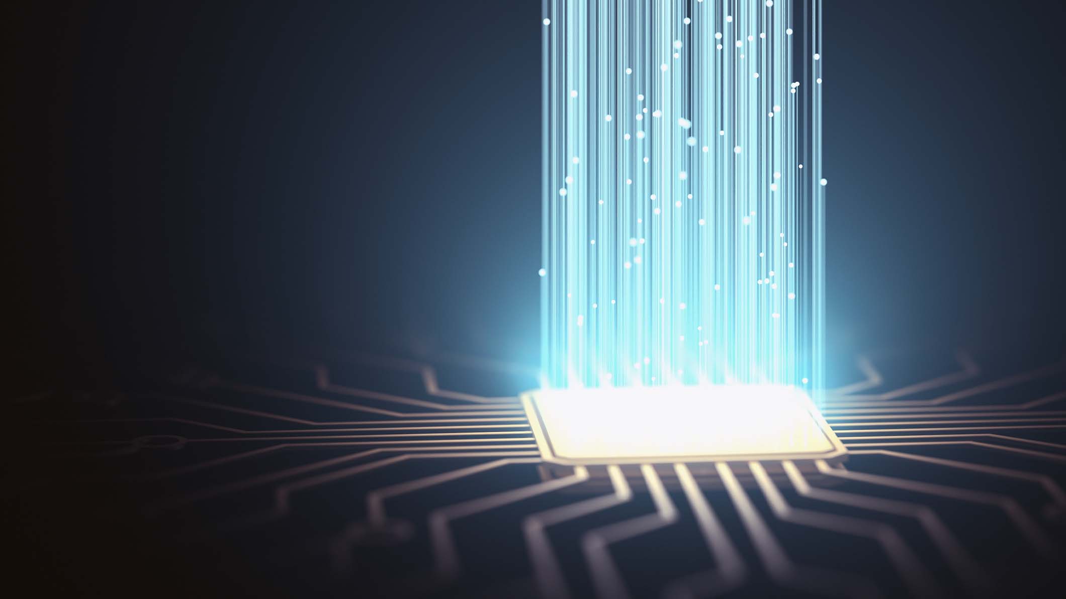 Ilustracja przedstawiająca chip komputerowy emitujący wiązki światła w górę